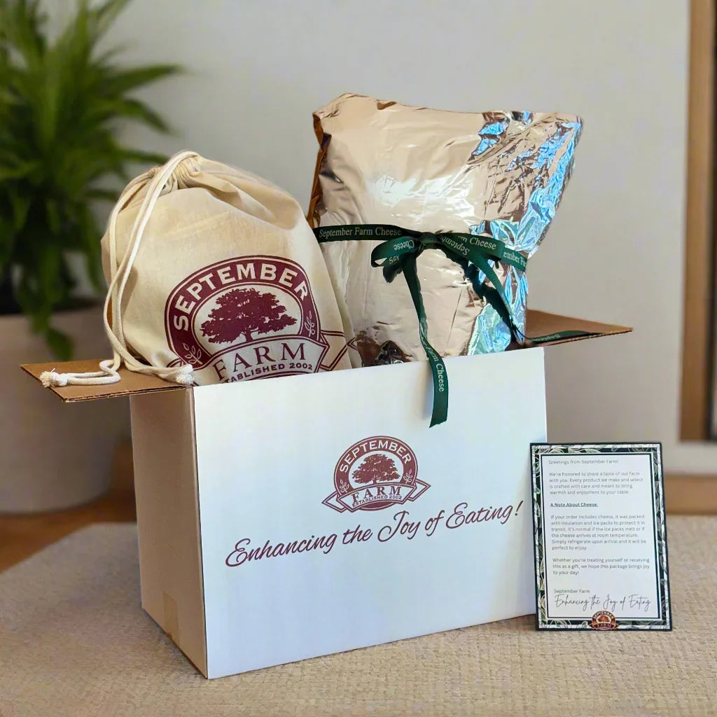 Gift box with September Farm branding on a wooden surface