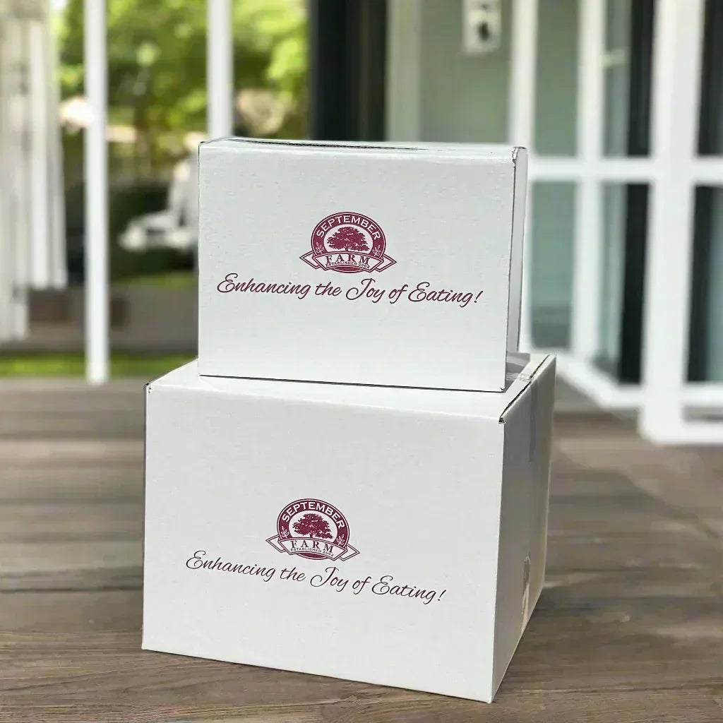 Two white boxes with a logo and text on them, placed outdoors.